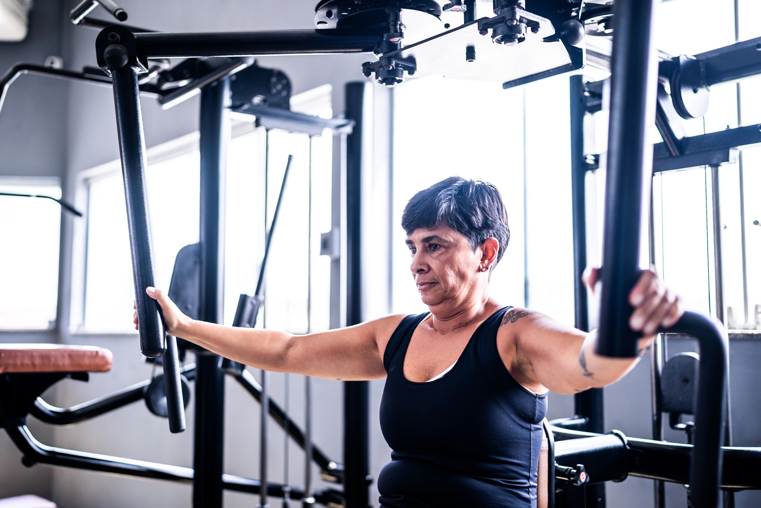 Older woman lifting weights in a gym